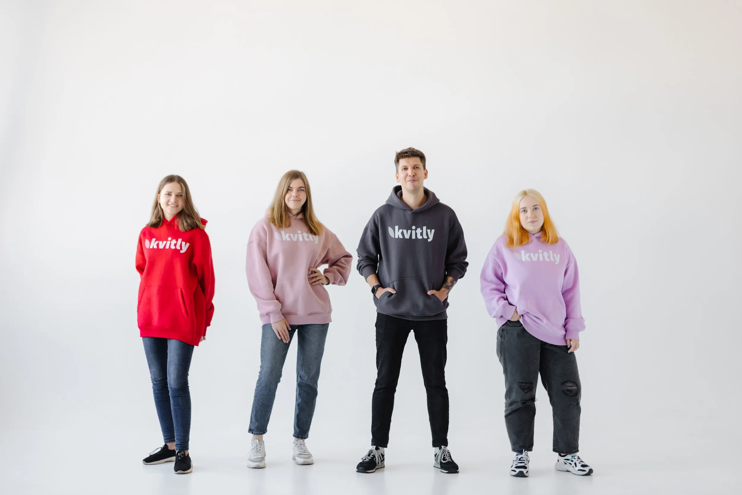 Whitney leaning against a railing on a downtown street